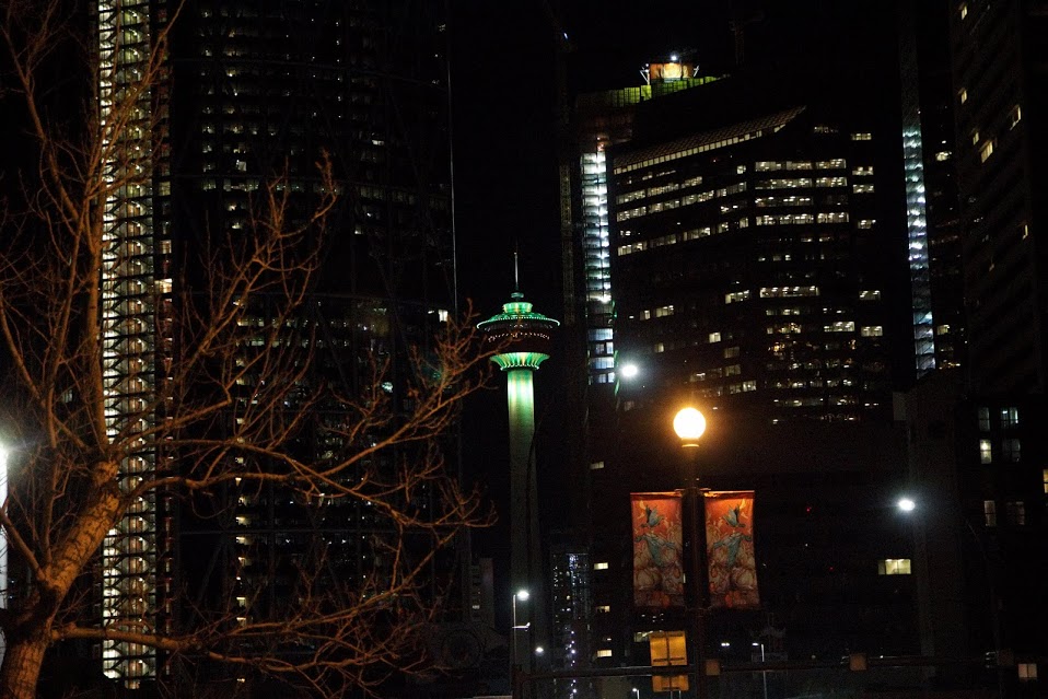 Calgary Tower Night Shot from inside the city, lit up with green lights